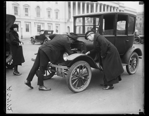 1921-1922. “Man and woman examining automobile engine. U.S. Capitol, Washington, D.C." Ha