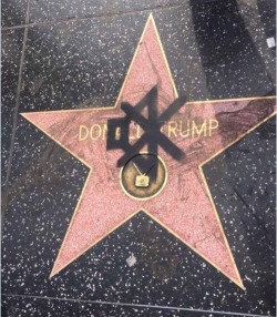 felidae-sapiens:  weavemama:  SOMEOME SPRAY PAINTED THE MUTE SIGN ON DONALD TRUMPS STAR LMAO  Reblog to empower the sigil! 