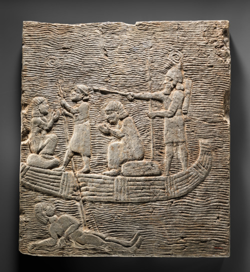 An Assyrian soldier conducts captives in a boat.  Gypsum alabaster relief, artist unknown; ca. 668-6