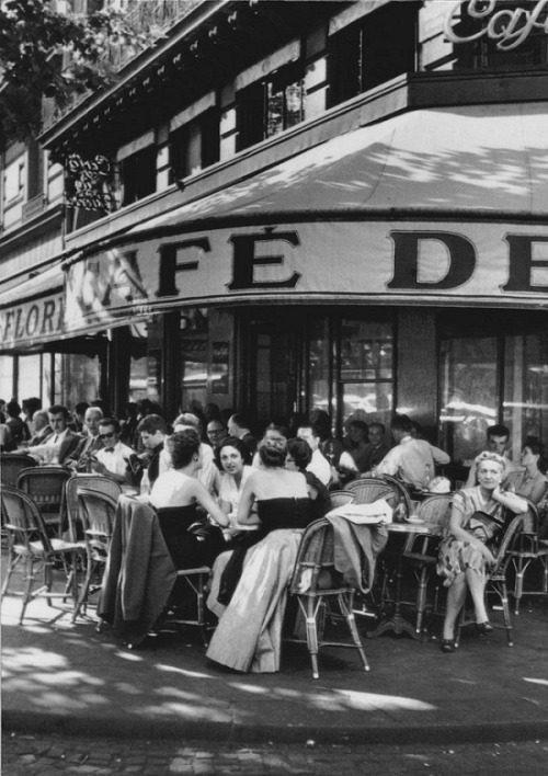 lesgrandsphotographes-deactivat:  Robert Capa. Café de Flore, place St Germain des Prés, Paris, 1952 