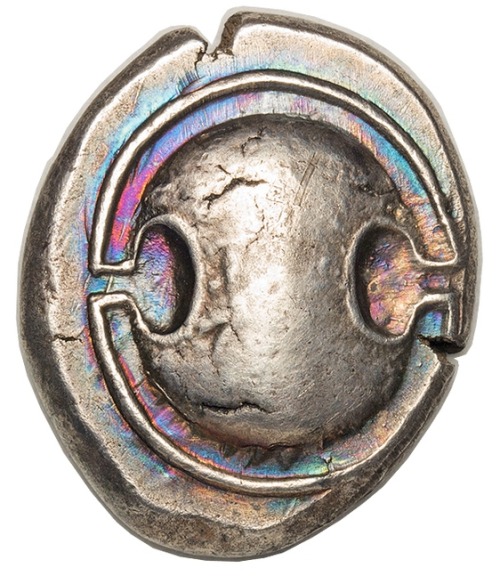 archaicwonder:Greek Coin from Boeotia with Iridescent ToningA silver stater from the city of Thebes,