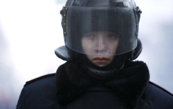 boyirl:  A riot policeman stands at his position