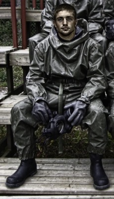 gaymasterandslave:  whipman-andy:  How long has he been sweating in his gear…?Obviously not long enough judging from his face (still smiling too much).So put that gasmask back on, pull the rubber hood of your suit up and we go back to the obstacle course.