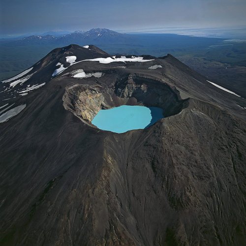 sixpenceee:  Karymsky Lake is a crater lake located in the Karymsky volcano in Russia. With a radius of 5 km it was once one of the world’s largest fresh water lakes, but as a result of a recent eruption toxic gases turned this into one of the largest