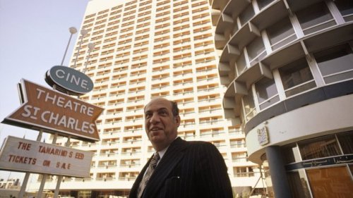 “The Beirut Holiday Inn rises behind the man who built it, Abdal Mohsin Kattan, in 1975. The H