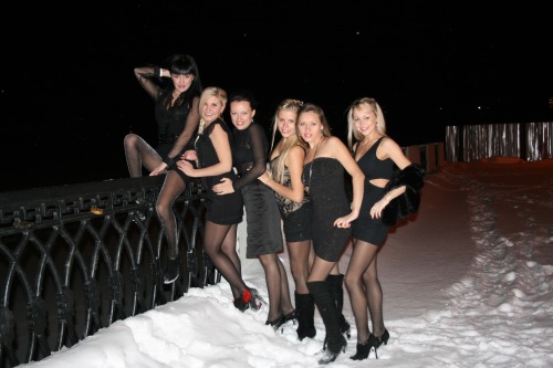 Hotties in tight dresses and black pantyhose having fun in the snow.Woman in pantyhose