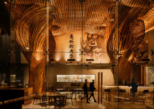 itscolossal: Swirling Plumes of Black-and-Gold Rattan Fill the Ceiling of a Bangkok Lounge