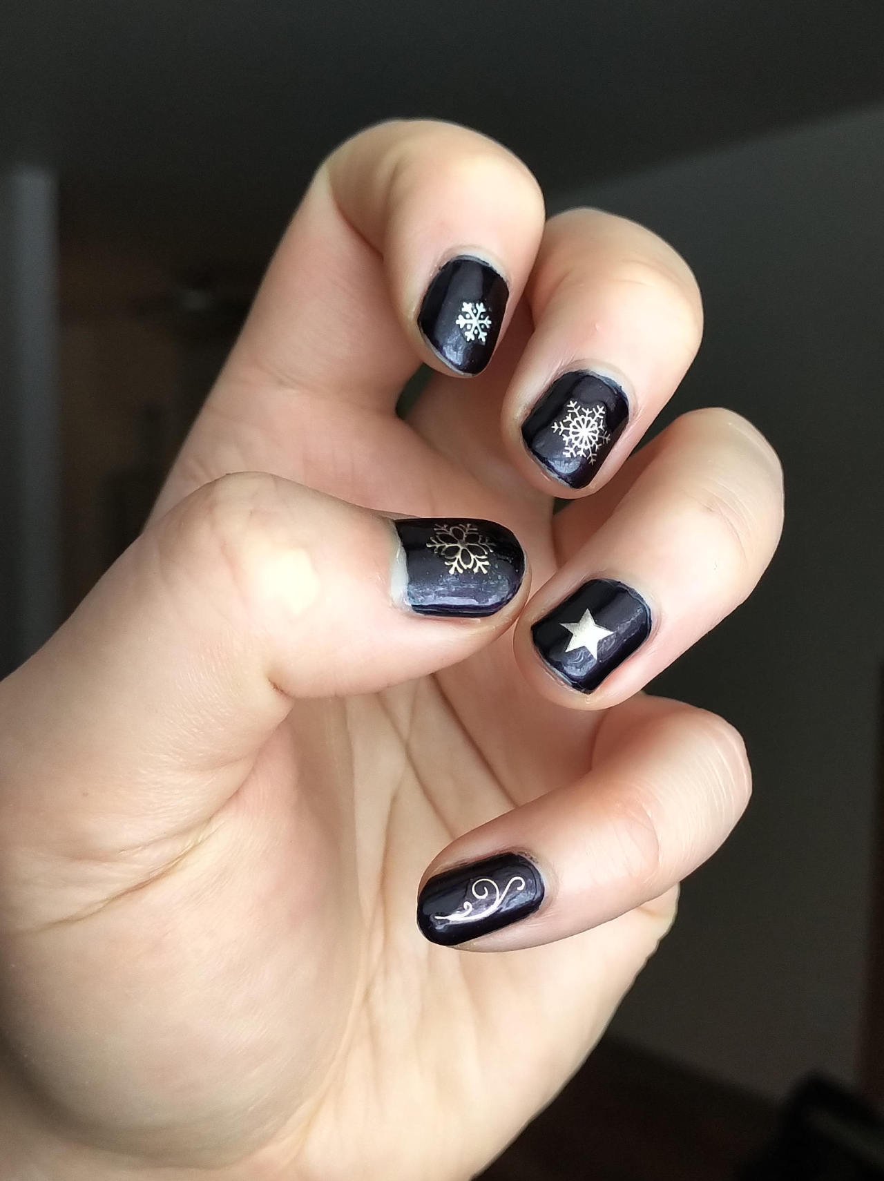 Continuing the festive goth nails, this was my new years look (photo taken after a several days of wear).  Sally Hansen Complete Salon Manicure in 641 Belle of the Ball is a deep blue-purple with subtle reddish shimmer.  In the bottle it looks to be a shimmery deep bordeaux red, but on the nail it comes out dark dark purple.   #nails #goth new year  #goth new year nails #snowflakes#nailstickers#sally hansen #Belle of the Ball  #Sally Hansen Belle of the Ball #festivegoth #festive goth nails