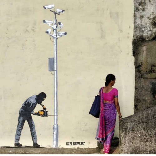 Anti-surveillance stencil in Andheri East, in Mumbai, Indiaby Tyler Street Art