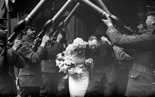 peashooter85:A happy couple passes under an arch of Lewis guns as they leave a church following thei