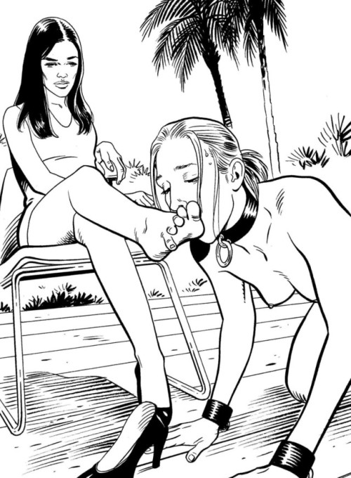 Collared slave girl kisses her mistress’s feet.