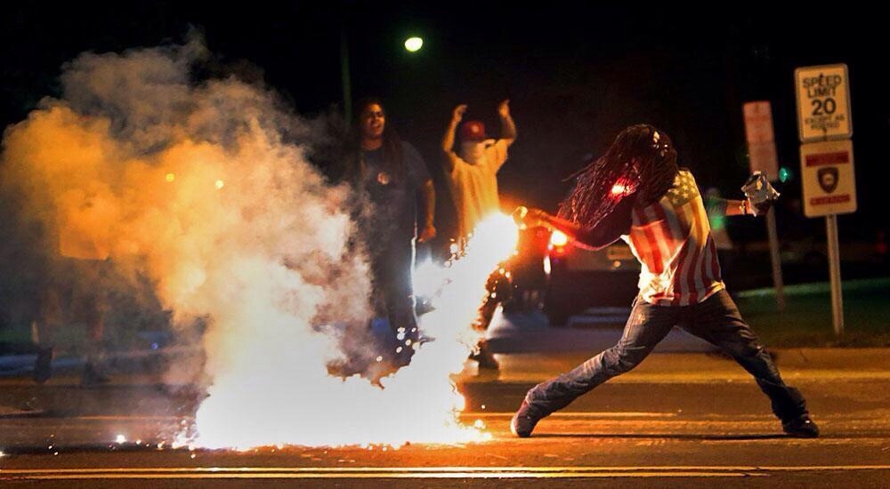 postwhitesociety:  darvinasafo:  #FERGUSON protestor returns tear gas canister back