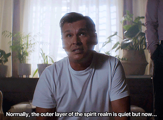 GIF FROM EPISODE 1X08 OF NANCY DREW. CHIEC MCGINNIS IS SITTING ON THE FLOOR IN NANCY'S HOUSE IN FRONT OF A WINDOW WITH LIGHT STREAMING IN BEHIND HIM. HE SAYS "NORMALLY, THE OUTER LAYER OF THE SPIRIT REALM IS QUIET BUT NOW...."