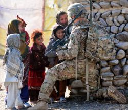 sexysoldiers:  You never stand so tall as when you get to the kids height and help kids smile.
