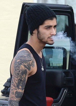 direct-news:  Zayn Malik puffs on a cigarette outside his £24-a-night hotel as he