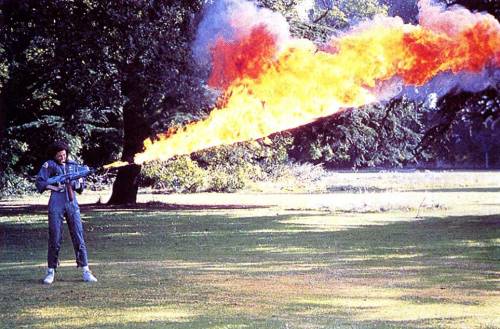 error888: Sigourney Weaver testing the flamethrower for Alien on the lawn at Shepperton Studios.