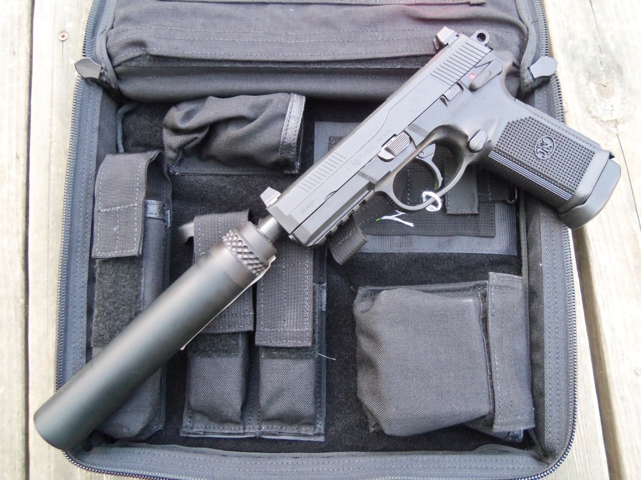 gunrunnerhell:  Shhh… A suppressed FNP-45 Tactical in black. It has a Gemtech Blackside