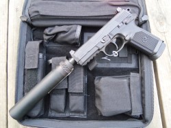 gunrunnerhell:  Shhh… A suppressed FNP-45 Tactical in black. It has a Gemtech Blackside suppressor. Capacity of the FNP is 15+1 rounds of .45 ACP. It has fairly distinct and rather prominent front and rear sights. While it may give a better sight picture,