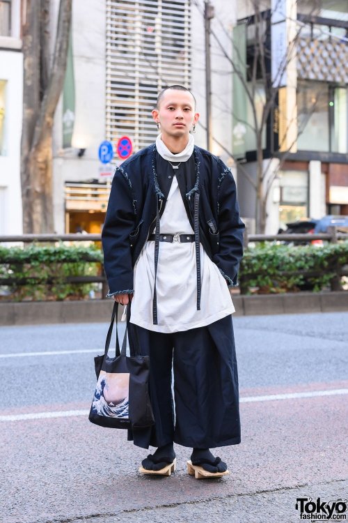 Japanese apparel worker Takamitsu on the street in Harajuku wearing a jacket and top from Not Conven