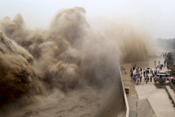 vxtacy:  diamonds-wood:  July 6, 2013. Visitors watch water gushing from the section of the Xiaolangdi Reservoir on the Yellow River, during a sand-washing operation in Jiyuan, Henan province, China.   minimal x urban x photography x art