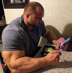 pjsesq:Big Hairy Russian Rock. Staring at his phone. Sergey Kulaev.