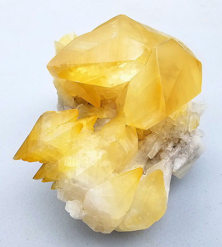 hematitehearts:    Golden Calcite crystals in cluster atop white Calcite  Locality: 