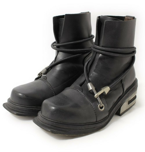 Held together with a black bungee cord.HIKING BOOTS WITH REINFORCED STEEL HEEL FROM DIRK BIKKEMBERGS