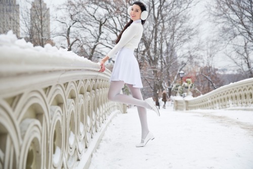 americanapparel:  Alanna in a winter wonderland wearing the Poplin Round Collar Short Sleeve Button-Up in White, Ponte Sleeveless Skater Dress in White, the Unisex Earmuffs in White, the Lightweight Crop Sweater in Creme and the Sparkle Pantyhose in White