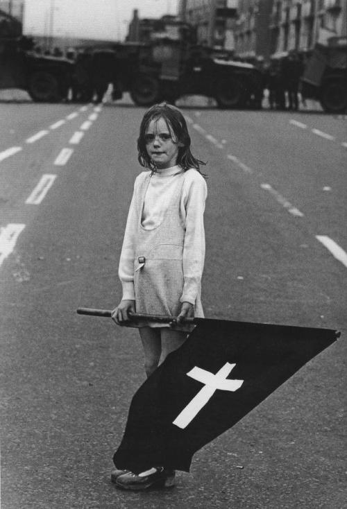 historicaltimes: Irish girl in a Catholic funeral procession, surrounded by British troops. Derry, 1