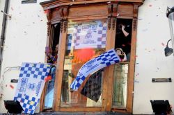 blue-madness-blue:  Cardiff City fans cheer their team on a day of sunshine celebrations across Cardiff marking their promotion to the Premier League.