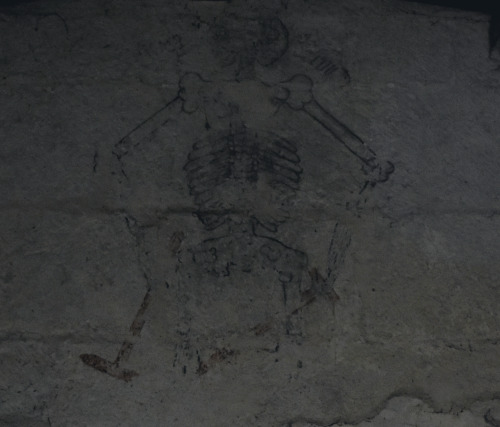 The fading remains of a medieval Giant skeleton painting dominates one wall of  St Lawrence Church- 