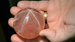 unearthedgemstones:  http://unearthedgemstones.tumblr.com/  The impressive size of this museum-quality star rose quartz can be seen by comparing it to the hand that holds it. It’s part of the gem collection at the Smithsonian Institution in Washington,