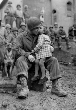 historicaltimes:  A little French girl kissing an American soldier after the liberation of France from German occupation, WWII, 1944 via reddit