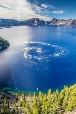 sixpenceee:  Giant Swirl At Crater Lake National Park, Oregon: Through the month of June and into July, yellow swirls of “stuff” can be seen on the surface of the lake and will always prompt great concern from the visitors. It’s not pollution or