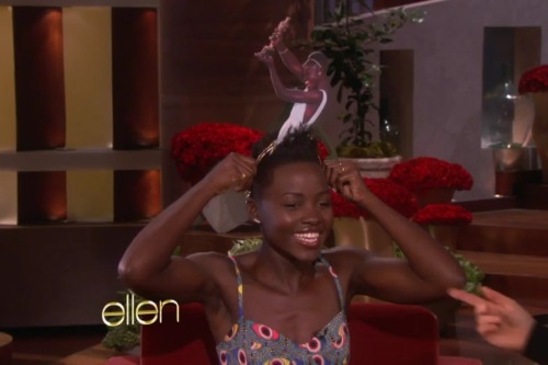 idlethumbsidleminds:  notkatniss:  Lupita Nyong’o is wearing a headband of a photo of her winning the Oscar  How can you not adore this lovely goddess? 