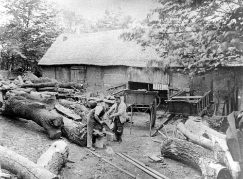 Thatched barn and carts, with woodcutters sawing tree trunks(Curdworth, Warwickshire, 1895).