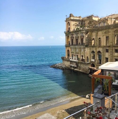 A peaceful view of Palazzo Donn'Anna, always charming with its three sides in the sea and just one o