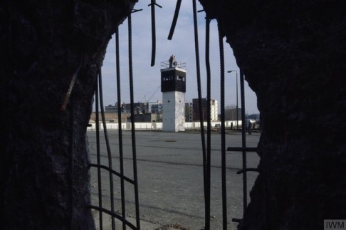 An East German observation tower seen through the remains of theBerlin Wall (January 23rd, 1990).