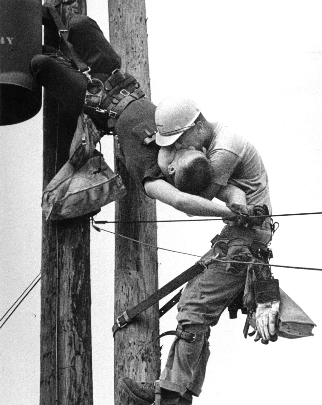  Kiss of Life. Utility worker, J.D. Thompson, suspended on a utility pole and giving