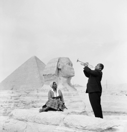 vintagegal:  Louis Armstrong plays for his wife, Lucille, in front of the Sphinx and Great pyramids in Giza, Egypt, 1961 (via)