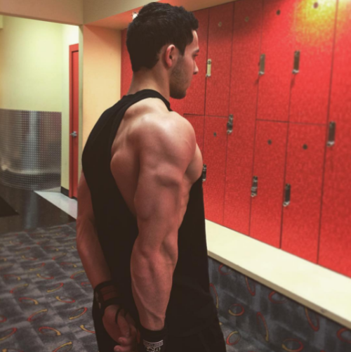 musclepuppy: Shoulder + Traps Day Flexed and waiting in the lockerroom for Coach&rsquo;s orders.