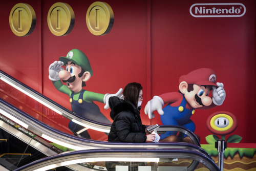 A customer leave an electronics store in Tokyo after buying the Nintendo Switch game console, Japan 