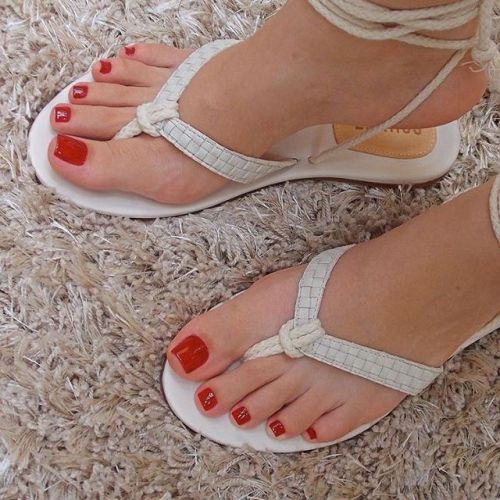 Pretty thong lace up sandals on pretty feet.