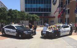 abcnews:  Dallas Police Dept. squad cars act as memorial in front of police headquarters.  