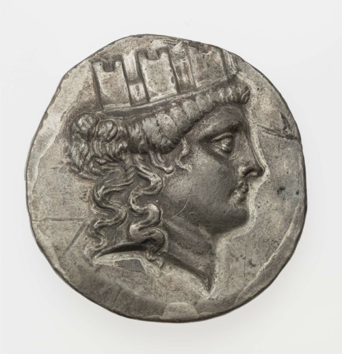 Silver tetradrachm of Smyrna with head of Cybele in turreted mural crown (obverse) and Greek inscrip