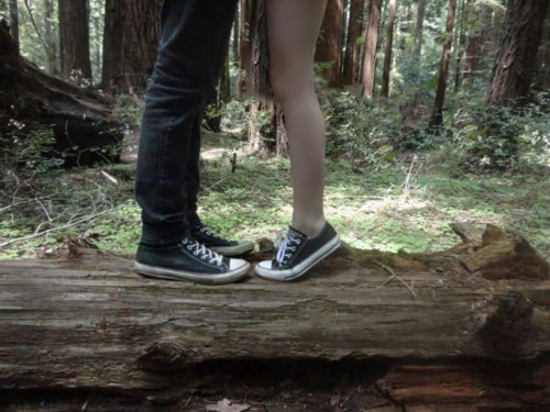 Three legs for two lovers. High amputee girl and guy. Kissing in the woods, standing on a tree trunk