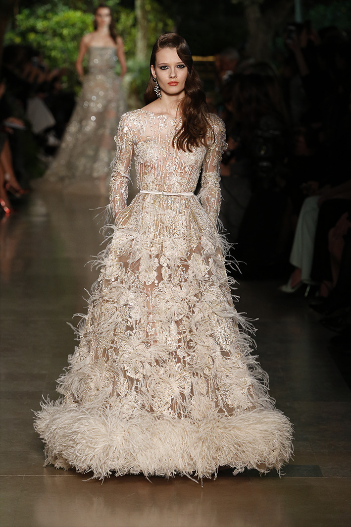 eliesaab:Ivory couture gowns dressed with lace and feathers, sequins and pearls.