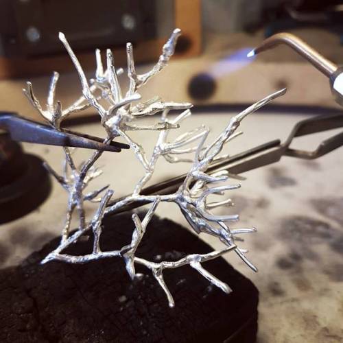 soldering silver neural branches.