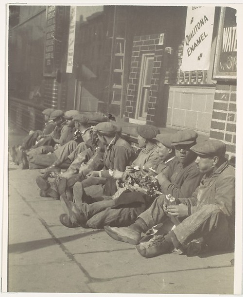 Workers Eating Lunch, Seated on Sidewalk, New York, by Walker Evans, 1928.