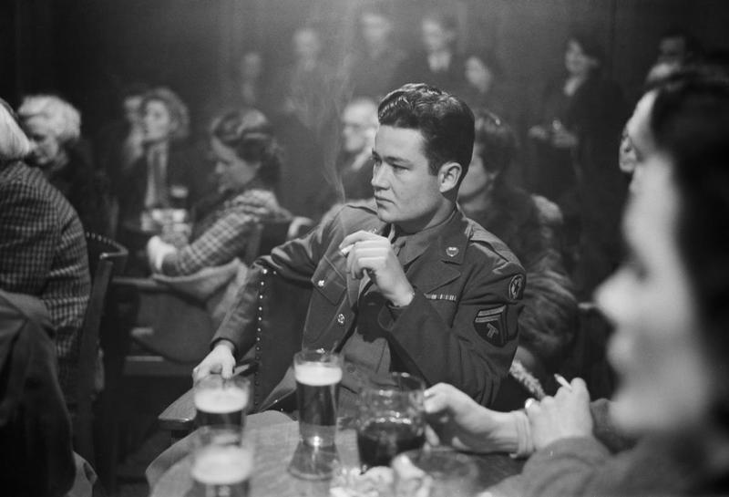 worldwar-two:  An American soldier listening to a speaker at a debating society meeting